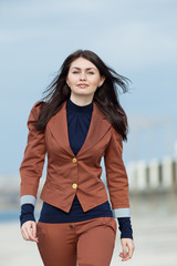 Young businesswoman walking along the seafront