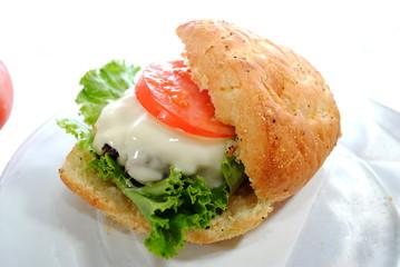 Burger Smothered in Cheese with lattuce and Tomato on a Bun