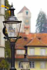 street lamps against the background of an ancient tower
