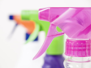 Three different colors sprayers closeup