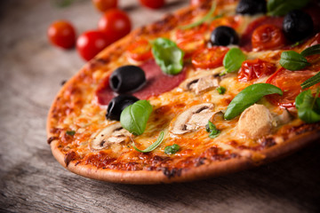 Tasty Italian pizza on wooden background