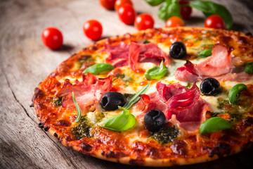 Tasty Italian pizza on wooden background