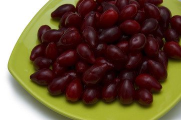 fresh cornel berries in bowl isolated on white