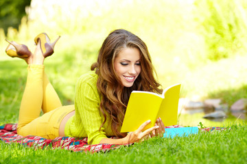 woman reading a book at the lawn