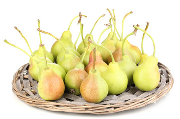 ripe pears on wicker mat isolated on white.