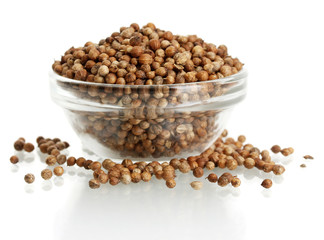 Heap coriander seeds in glass bowl isolated on white