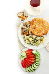 Roast chicken cutlet with boiled potatoes and mushrooms, cup of