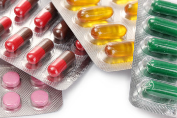 Capsules and pills packed in blisters, close up