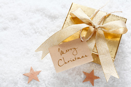 Gold gift with Merry Christmas tag