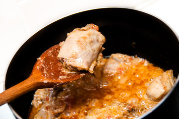 Close up of Chicken curry being cooked in apn