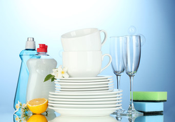 empty clean plates, glasses and cups with dishwashing liquid,