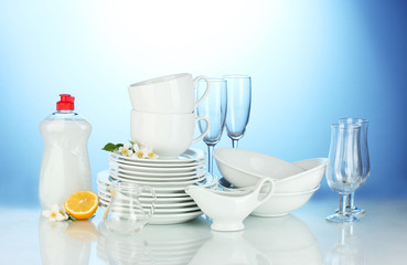 empty clean plates, glasses and cups with dishwashing liquid
