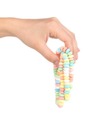 Color candies in hand isolated on white