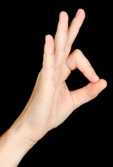 Hand making sign isolated on black