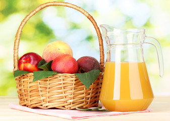 Ripe peaches in basket and juice