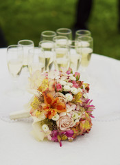 Bridal bouquet on table with glasses