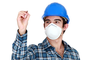 Young builder wearing a mask