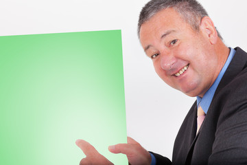 Man holding and pointing at blank green sign