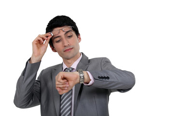 Businessman looking at watch