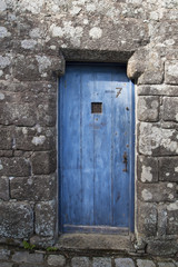 old blue wooden door in a stone wall