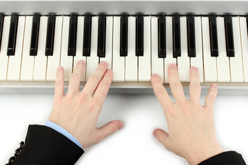 hands of man playing piano