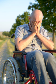Verzweifelter Mann im Rollstuhl