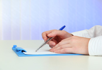 Closeup of businesswoman hands, writing on paper