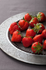strawberry on vintage plate