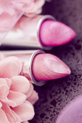 pink lipsticks and flower petals