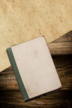Weathered book and paper on wood