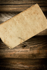 Crumpled old paper on wood