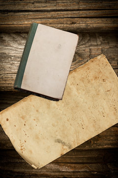 Vintage book and paper on a dark wooden background