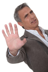 irritated man making a stop hand sign