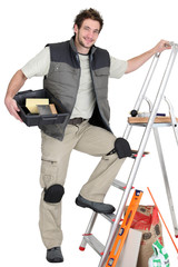 Tiler about to climb ladder