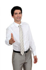 A businessman about to shake hands.