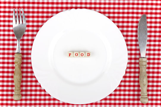 Food - lettering on white plate and nostalgic cutlery
