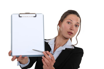Business professional pointing to a clipboard