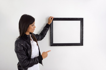 Woman pointing to a picture frame
