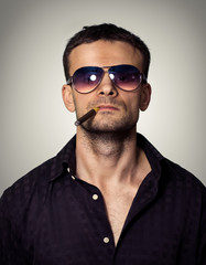 Man in sunglasses with a cigar