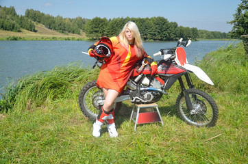 Girl with her hair around a motocross bike