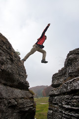 Man jump between rock