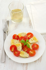 salad with artichoke on the white plate