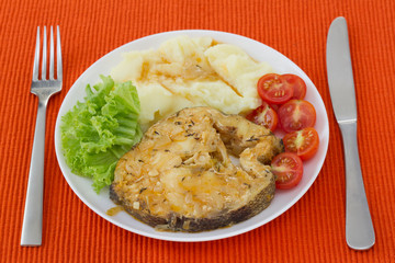 fish in sauce with mashed potato on the plate