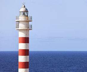 Red and white lighthouse, Faro de Punta Sardina in Gran Canaria