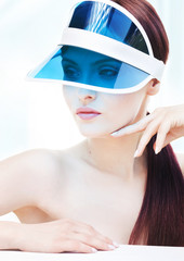 Portrait of attractive young adult woman with sun visor