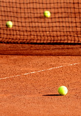 Tennis balls on a tennis clay court