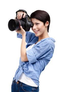 Woman takes images holding photographic camera