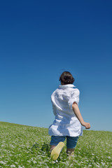 Young happy woman in green field