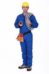 Tradesman holding his tools and corrugated tubing