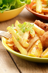 Fried drumsticks with french fries